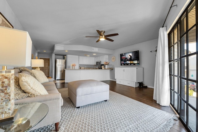 living area featuring baseboards, visible vents, a ceiling fan, and dark wood-style flooring