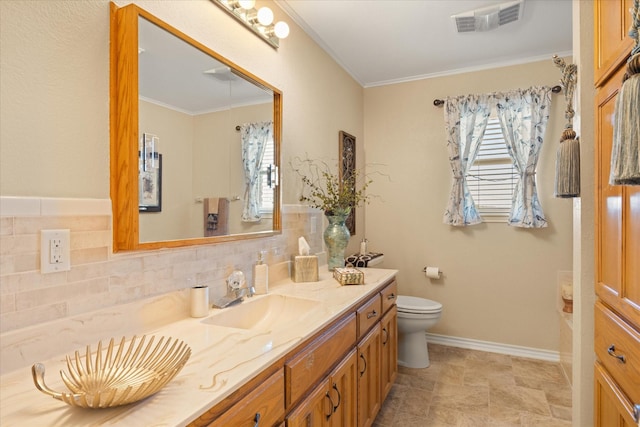 full bath with crown molding, visible vents, toilet, vanity, and baseboards