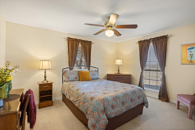 carpeted bedroom featuring ceiling fan and baseboards