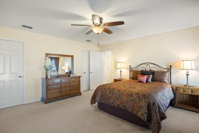 carpeted bedroom featuring visible vents, ceiling fan, and baseboards