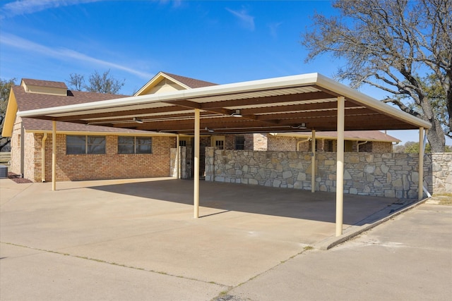 view of parking featuring a carport and concrete driveway