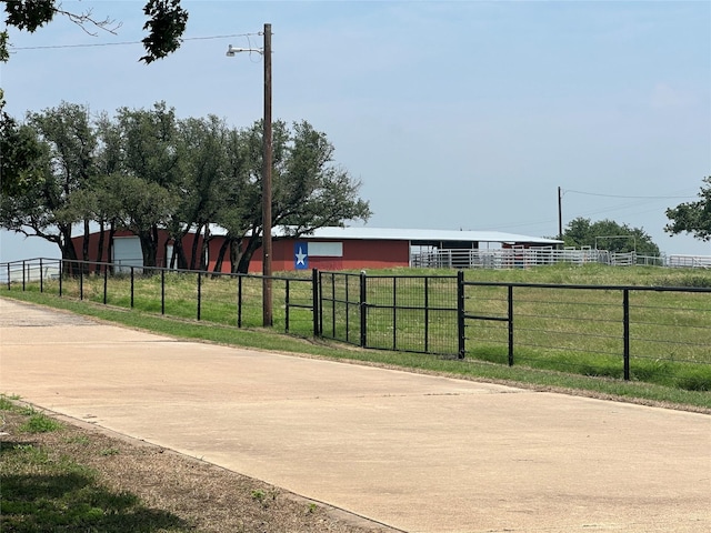 exterior space featuring an outbuilding, a yard, an outdoor structure, and fence