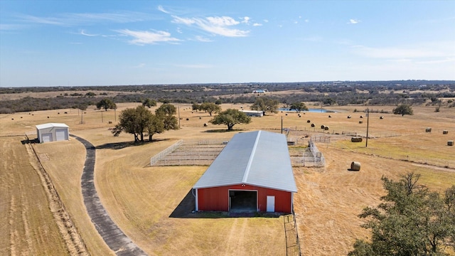 birds eye view of property with a rural view