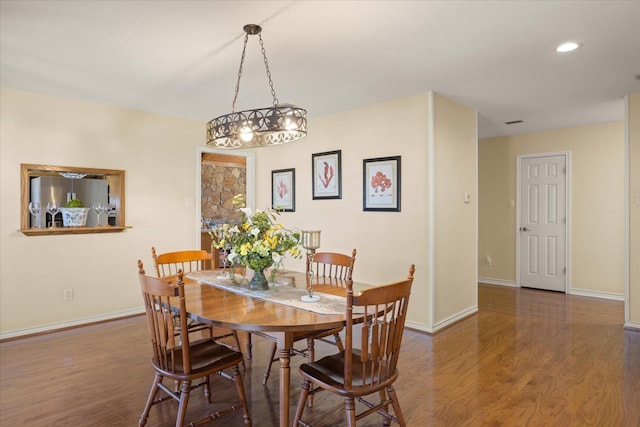 dining space featuring recessed lighting, wood finished floors, and baseboards