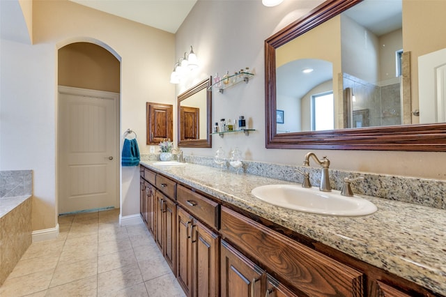 2807 Millington Dr, Highland Village, TX 75077 - bathroom featuring double vanity, a sink, a tile shower, and tile patterned floors