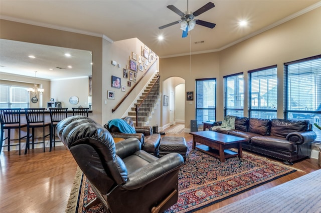 2807 Millington Dr, Highland Village, TX 75077 - living room featuring arched walkways, visible vents, wood finished floors, stairs, and crown molding