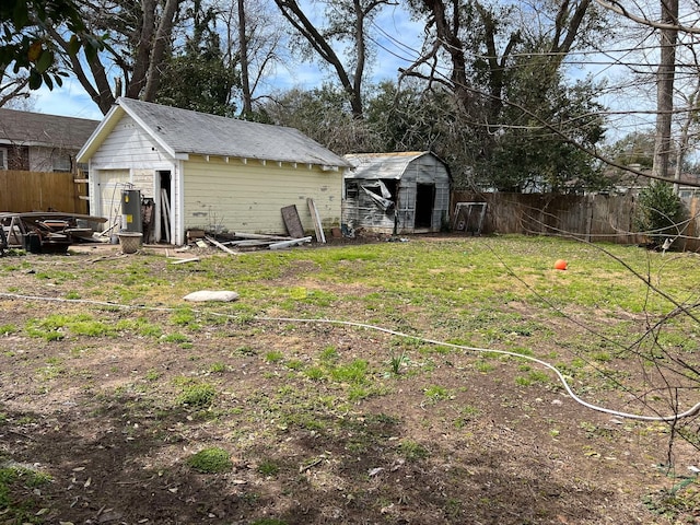 view of yard featuring a storage shed, an outbuilding, and a fenced backyard