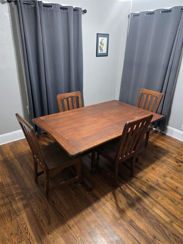 dining room with baseboards and wood finished floors