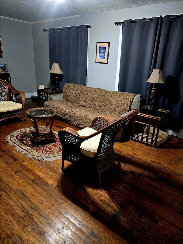 living room with hardwood / wood-style floors and crown molding