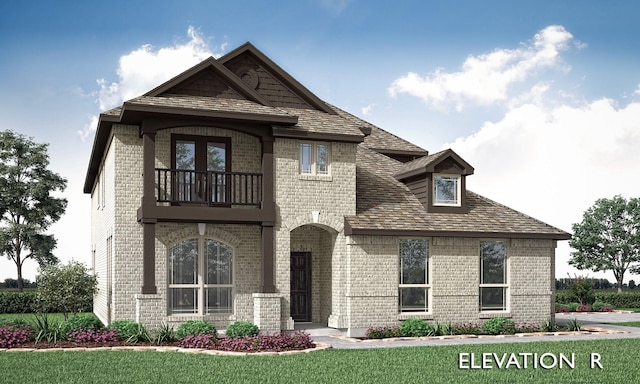 view of front of property featuring a front yard, brick siding, and a balcony