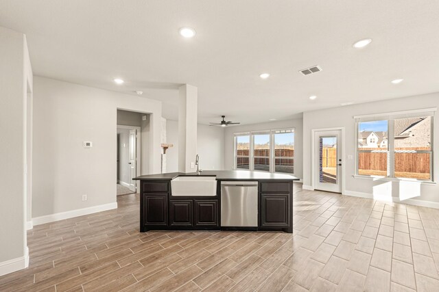 living area featuring a wealth of natural light, ceiling fan, visible vents, and wood finished floors