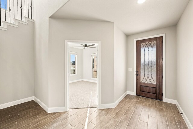 kitchen with stainless steel appliances, wood finished floors, a sink, and white cabinetry