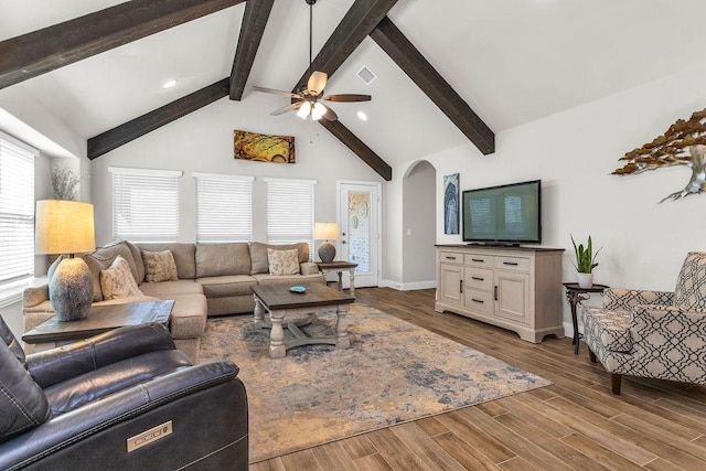 living room with high vaulted ceiling, a ceiling fan, wood finished floors, arched walkways, and baseboards