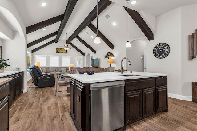 kitchen with visible vents, open floor plan, dishwasher, light countertops, and a sink