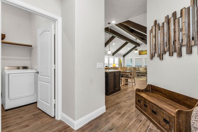 corridor with vaulted ceiling with beams, baseboards, wood tiled floor, recessed lighting, and washer / dryer