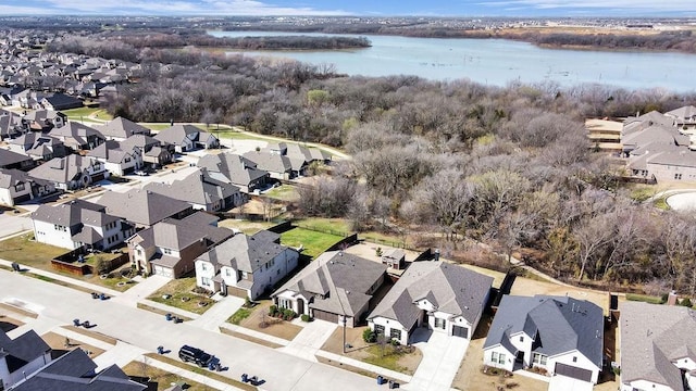 drone / aerial view featuring a residential view and a water view