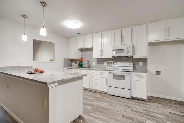 kitchen featuring light wood-type flooring, white appliances, white cabinets, and a sink