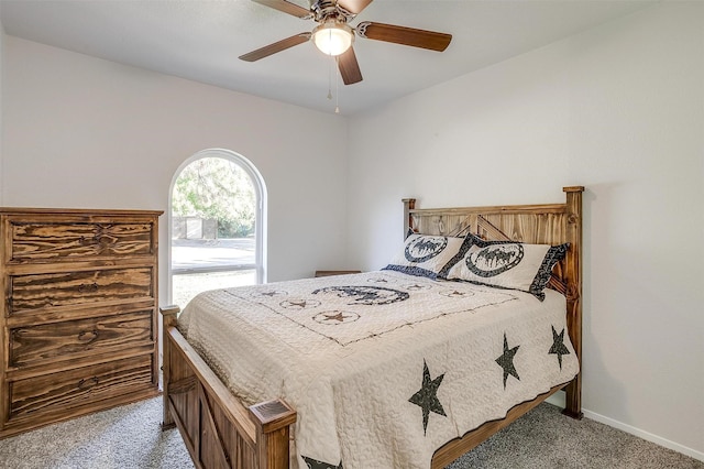 bedroom with light carpet, ceiling fan, and baseboards