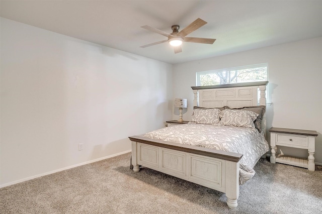 bedroom featuring light carpet, a ceiling fan, and baseboards