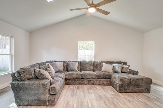 living room with lofted ceiling with beams, baseboards, a ceiling fan, and wood finished floors