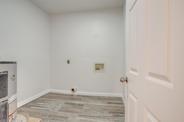 washroom featuring hookup for a washing machine, water heater, light wood-style floors, hookup for an electric dryer, and laundry area