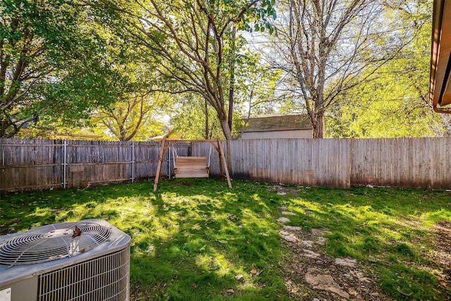 view of yard featuring a fenced backyard and central AC unit