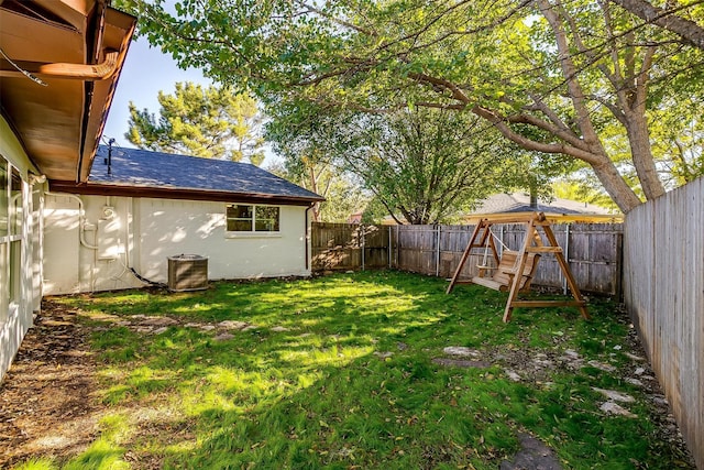 view of yard with a fenced backyard and a playground