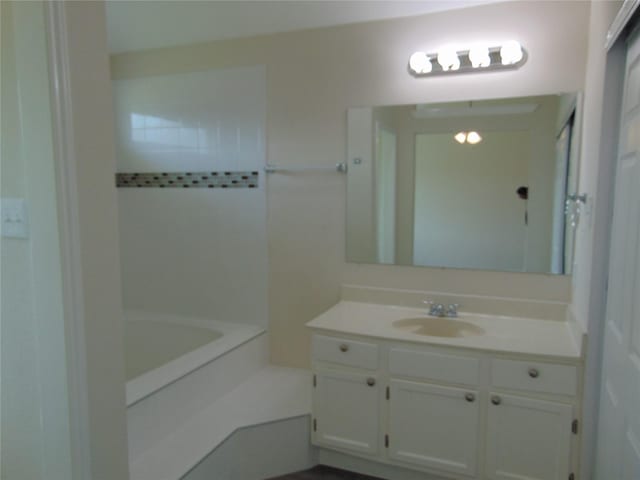 bathroom featuring  shower combination and vanity