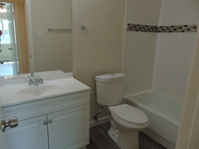 bathroom with shower / tub combination, vanity, toilet, and wood finished floors