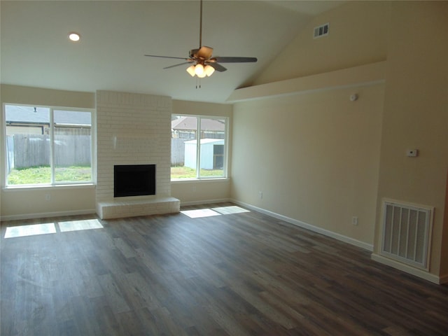 unfurnished living room featuring dark wood-type flooring, visible vents, and plenty of natural light