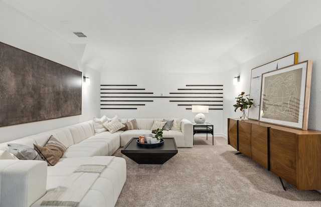 living area with visible vents and light colored carpet