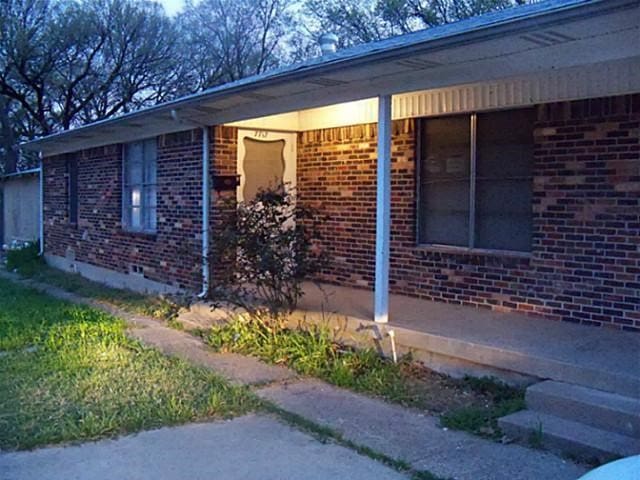 view of side of home featuring crawl space and brick siding