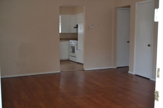 spare room with light wood-style flooring and baseboards