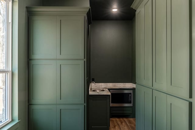 bathroom featuring wood finished floors, a sink, and recessed lighting