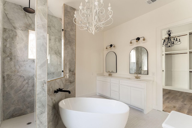 full bath featuring double vanity, a freestanding tub, walk in shower, and a sink