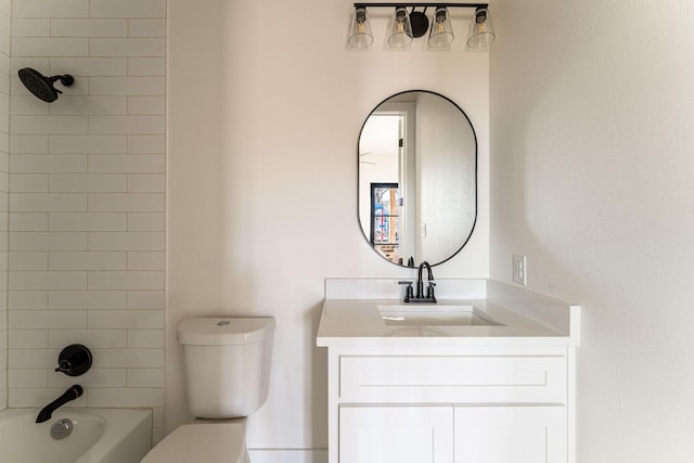 bathroom featuring toilet, shower / bathing tub combination, and vanity