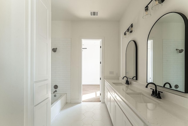 full bathroom featuring double vanity, shower / bath combination, a sink, and tile patterned floors