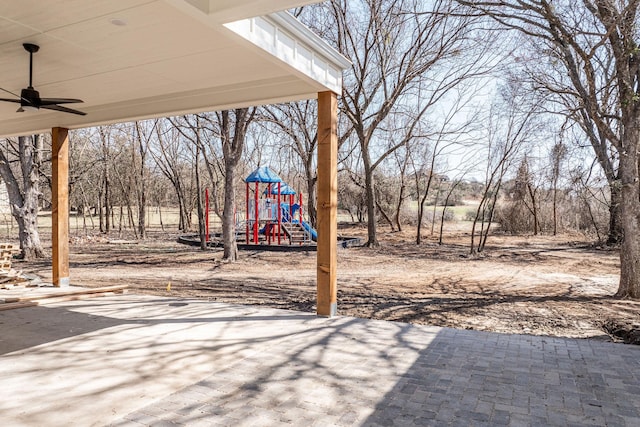 view of yard with ceiling fan and playground community