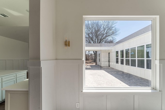 entryway featuring a wainscoted wall and visible vents