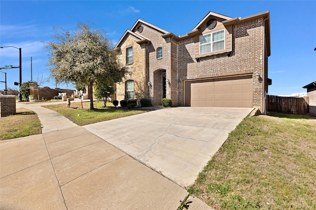 view of front of home featuring a front yard, brick siding, and an attached garage