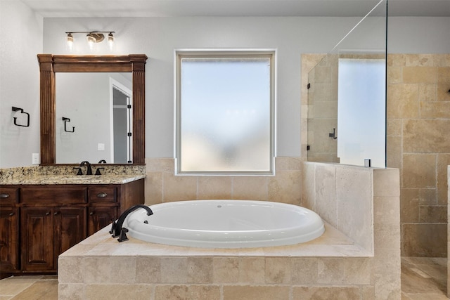 full bath featuring a garden tub, a walk in shower, and vanity