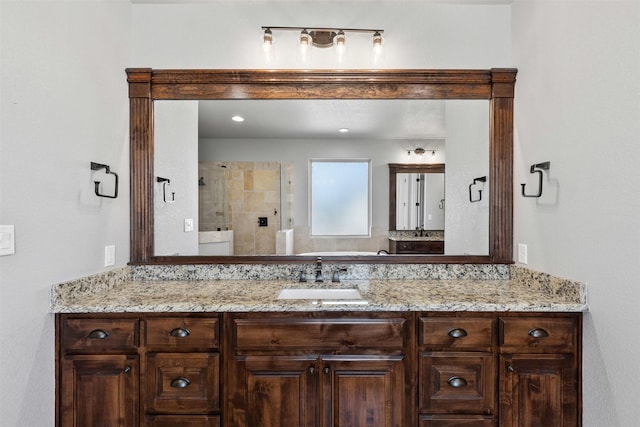 bathroom featuring a stall shower and vanity