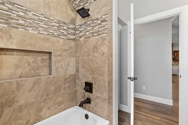 full bathroom with  shower combination, wood finished floors, and baseboards