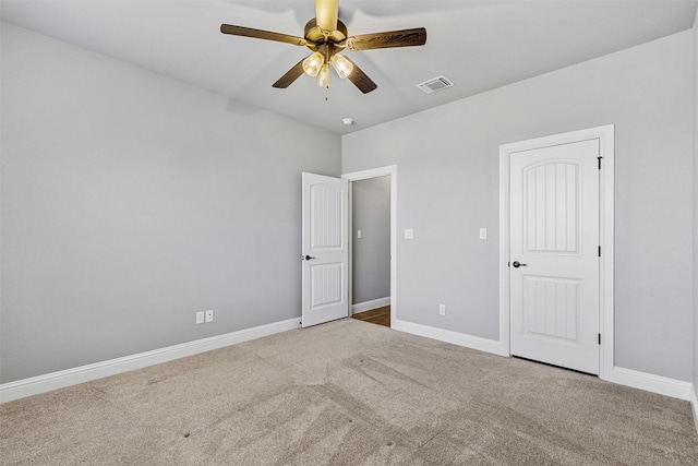 unfurnished bedroom with carpet flooring, visible vents, and baseboards