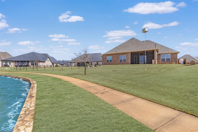 view of community with a residential view and a lawn