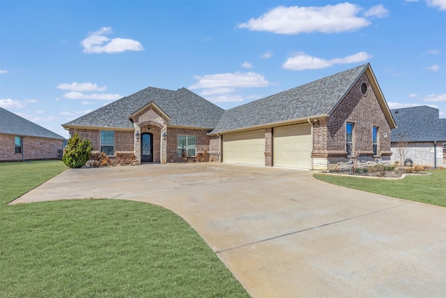 french country home with roof with shingles, a front yard, and brick siding