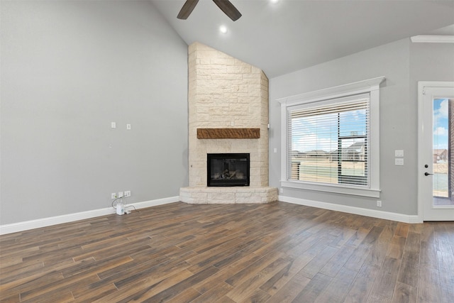 unfurnished living room with plenty of natural light, a fireplace, baseboards, and dark wood-type flooring