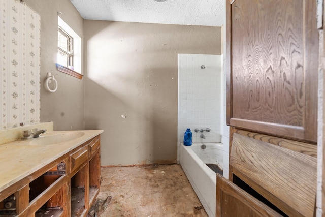 full bathroom with shower / bathing tub combination, vanity, and a textured ceiling