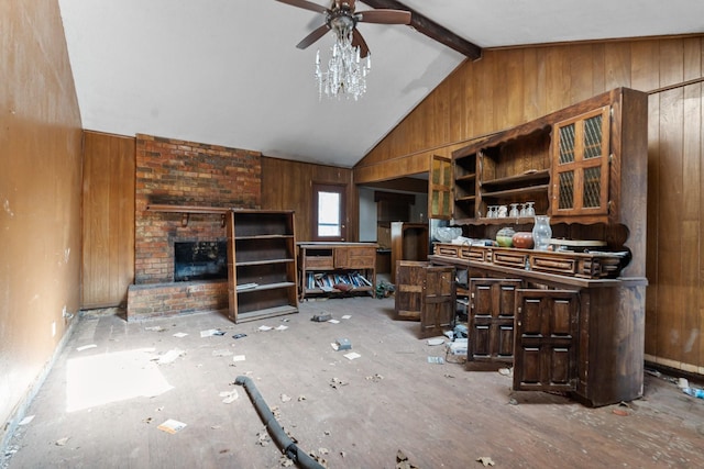 living room featuring vaulted ceiling with beams, ceiling fan, wooden walls, and a fireplace