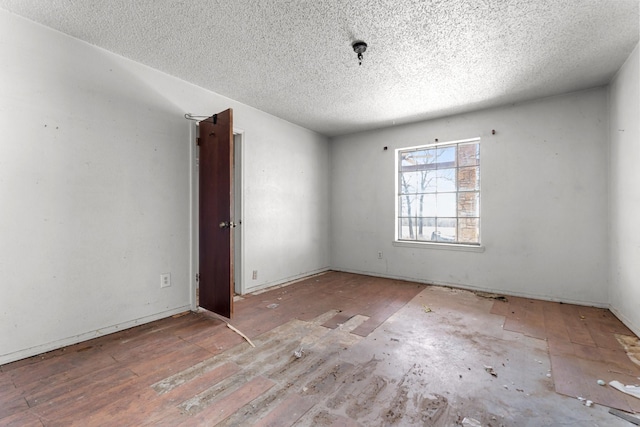 spare room with a textured ceiling